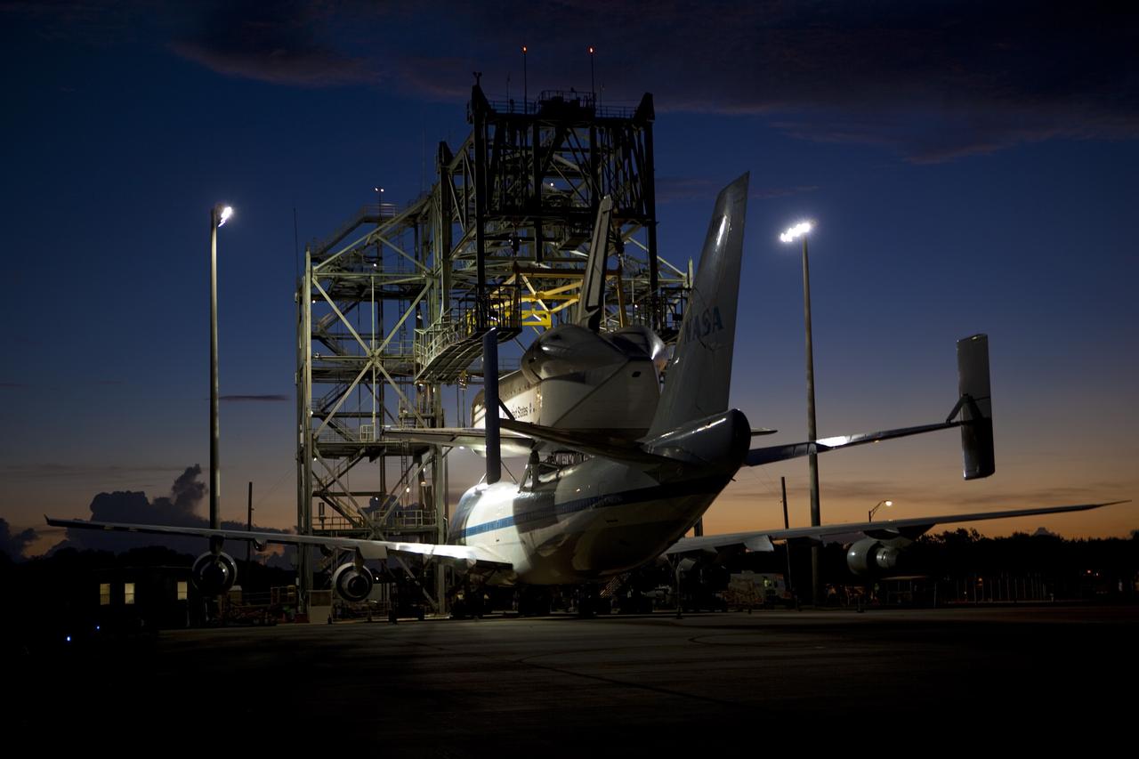 CAPE CANAVERAL, Fla. – Dawn at the Shuttle Landing Facility at NASA's Kennedy Space Center in Florida reveals space shuttle Endeavour secured atop NASA's Shuttle Carrier Aircraft, or SCA. Preparations are under way to roll them away from the mate-demate device surrounding them. The SCA, a modified 747 jetliner, will fly Endeavour to Los Angeles where it will be placed on public display at the California Science Center. This is the final ferry flight scheduled in the Space Shuttle Program era. For more information on the shuttles' transition and retirement, visit http://www.nasa.gov/transition. Photo credit: NASA/Dimitri Gerondidakis