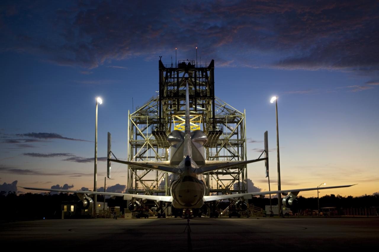 CAPE CANAVERAL, Fla. – Sunrise at the Shuttle Landing Facility at NASA's Kennedy Space Center in Florida finds space shuttle Endeavour secured atop NASA's Shuttle Carrier Aircraft, or SCA. Preparations are under way to roll them away from the mate-demate device surrounding them.    The SCA, a modified 747 jetliner, will fly Endeavour to Los Angeles where it will be placed on public display at the California Science Center. This is the final ferry flight scheduled in the Space Shuttle Program era. For more information on the shuttles' transition and retirement, visit http://www.nasa.gov/transition.  Photo credit: NASA/Dimitri Gerondidakis