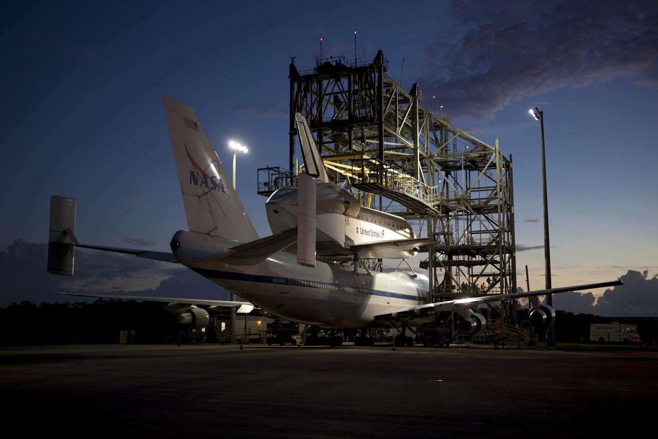 CAPE CANAVERAL, Fla. – Sunrise at the Shuttle Landing Facility at NASA's Kennedy Space Center in Florida finds space shuttle Endeavour secured atop NASA's Shuttle Carrier Aircraft, or SCA. Preparations are under way to roll them away from the mate-demate device surrounding them. The SCA, a modified 747 jetliner, will fly Endeavour to Los Angeles where it will be placed on public display at the California Science Center. This is the final ferry flight scheduled in the Space Shuttle Program era. For more information on the shuttles' transition and retirement, visit http://www.nasa.gov/transition. Photo credit: NASA/Dimitri Gerondidakis