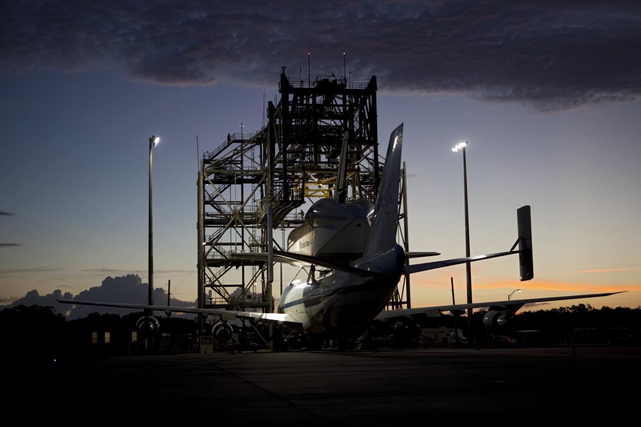CAPE CANAVERAL, Fla. – Sunrise at the Shuttle Landing Facility at NASA's Kennedy Space Center in Florida finds space shuttle Endeavour secured atop NASA's Shuttle Carrier Aircraft, or SCA. Preparations are under way to roll them away from the mate-demate device surrounding them. The SCA, a modified 747 jetliner, will fly Endeavour to Los Angeles where it will be placed on public display at the California Science Center. This is the final ferry flight scheduled in the Space Shuttle Program era. For more information on the shuttles' transition and retirement, visit http://www.nasa.gov/transition. Photo credit: NASA/Dimitri Gerondidakis