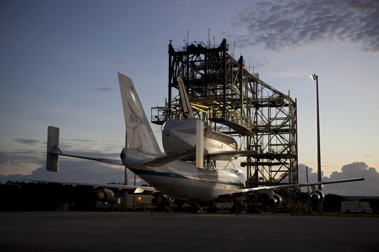 CAPE CANAVERAL, Fla. – Sunrise at the Shuttle Landing Facility at NASA's Kennedy Space Center in Florida finds space shuttle Endeavour secured atop NASA's Shuttle Carrier Aircraft, or SCA. Preparations are under way to roll them away from the mate-demate device surrounding them.    The SCA, a modified 747 jetliner, will fly Endeavour to Los Angeles where it will be placed on public display at the California Science Center. This is the final ferry flight scheduled in the Space Shuttle Program era. For more information on the shuttles' transition and retirement, visit http://www.nasa.gov/transition.  Photo credit: NASA/Dimitri Gerondidakis
