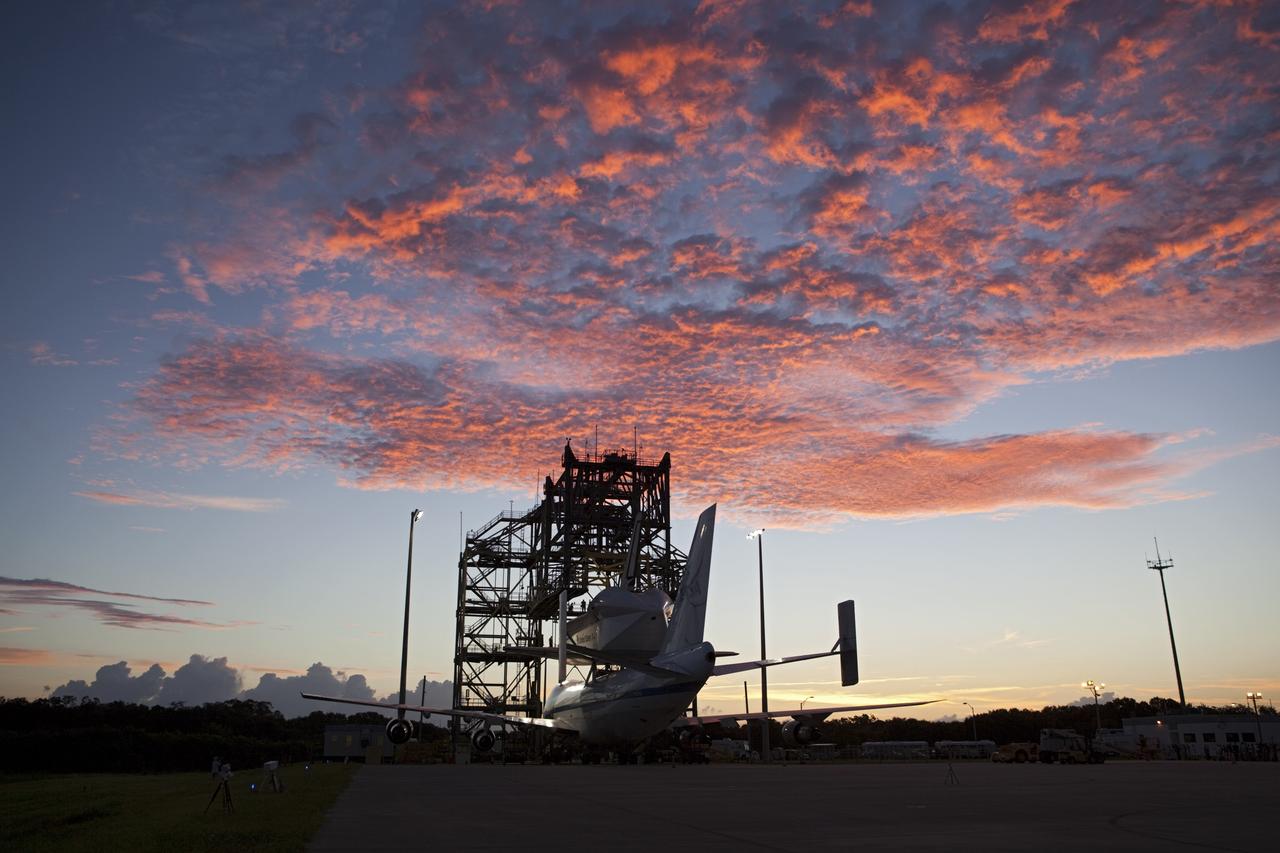 CAPE CANAVERAL, Fla. – The sky is ablaze over the Shuttle Landing Facility at NASA's Kennedy Space Center in Florida.  Preparations are under way to roll NASA's Shuttle Carrier Aircraft, or SCA, away from the mate-demate device surrounding it.  Space shuttle Endeavour has been fitted with an aerodynamic tailcone and secured atop the aircraft for its upcoming ferry flight.    The SCA, a modified 747 jetliner, will fly Endeavour to Los Angeles where it will be placed on public display at the California Science Center. This is the final ferry flight scheduled in the Space Shuttle Program era. For more information on the shuttles' transition and retirement, visit http://www.nasa.gov/transition.  Photo credit: NASA/Dimitri Gerondidakis