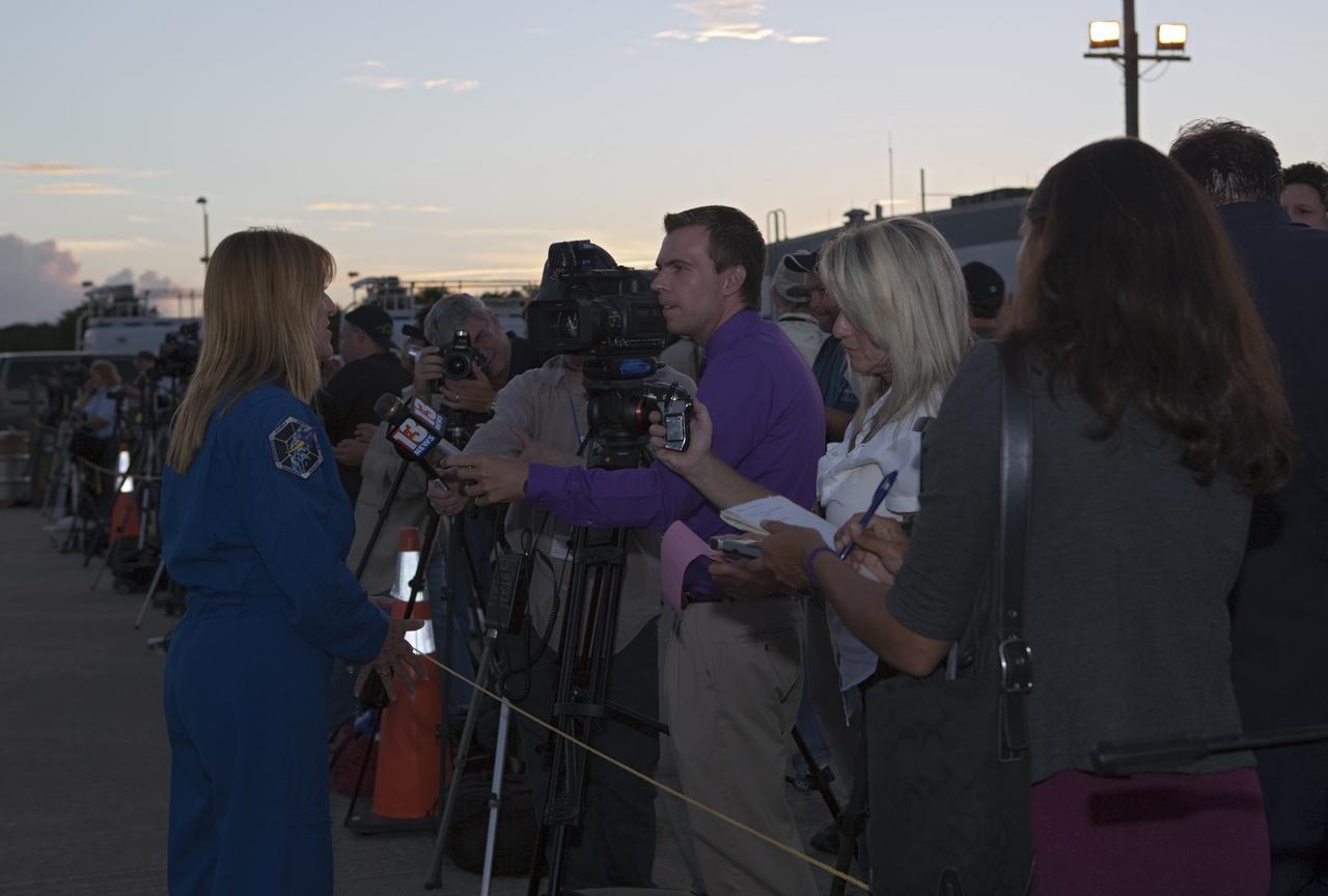 CAPE CANAVERAL, Fla. – Media representatives turn out to interview astronaut Kay Hire at the Shuttle Landing Facility at NASA's Kennedy Space Center in Florida. Preparations are under way for space shuttle Endeavour's upcoming ferry flight atop NASA's Shuttle Carrier Aircraft, or SCA.      The SCA, a modified 747 jetliner, will fly Endeavour to Los Angeles where it will be placed on public display at the California Science Center. This is the final ferry flight scheduled in the Space Shuttle Program era. For more information on the shuttles' transition and retirement, visit http://www.nasa.gov/transition.  Photo credit: NASA/Dimitri Gerondidakis