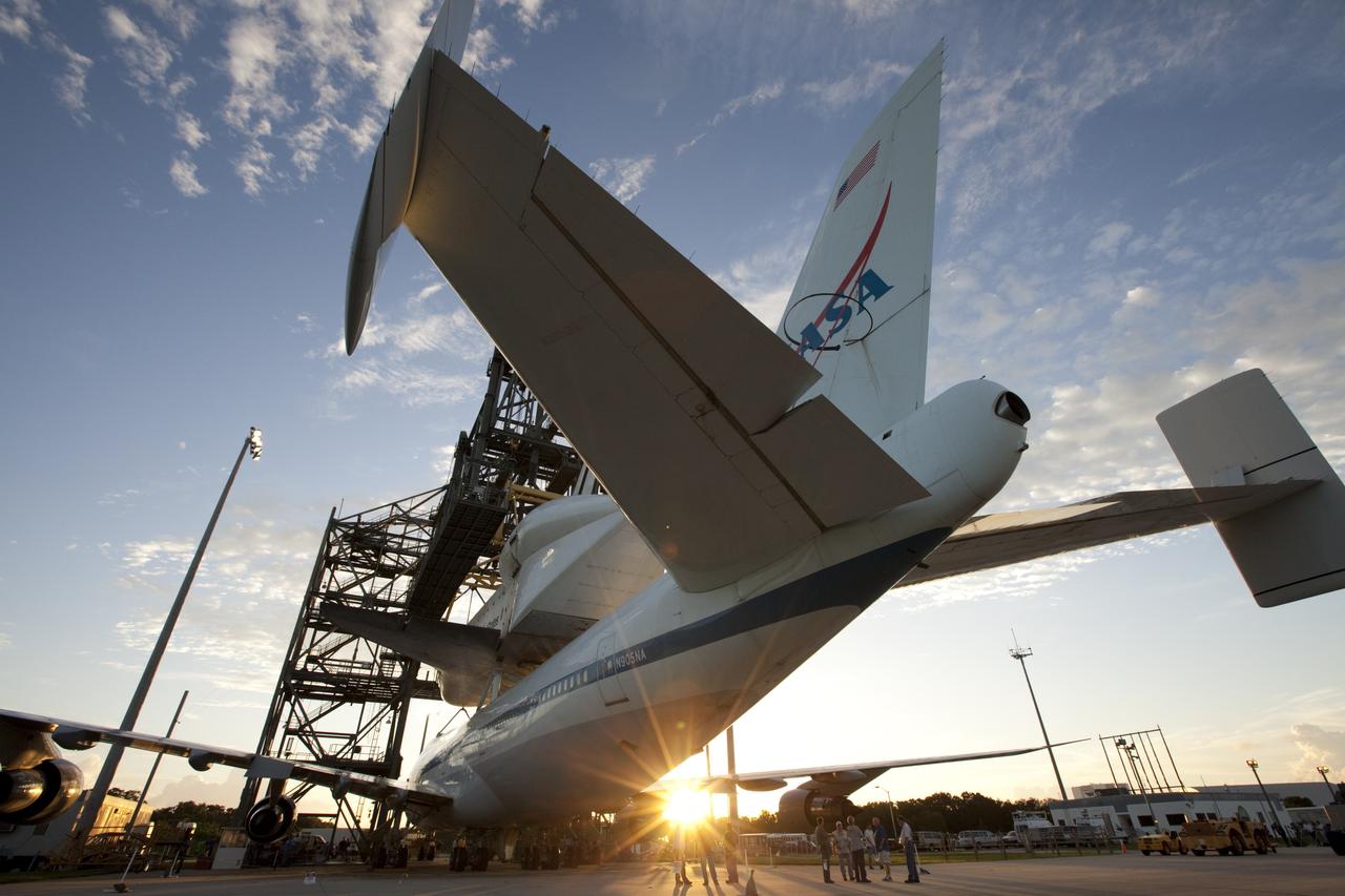 CAPE CANAVERAL, Fla. – At the Shuttle Landing Facility at NASA's Kennedy Space Center in Florida, rays from the early morning sun catch the space shuttle Endeavour, mounted atop NASA's Shuttle Carrier Aircraft, or SCA, as it is prepared to roll back from the mate-demate device.      The SCA, a modified 747 jetliner, will fly Endeavour to Los Angeles where it will be placed on public display at the California Science Center. This is the final ferry flight scheduled in the Space Shuttle Program era. For more information on the shuttles' transition and retirement, visit http://www.nasa.gov/transition.  Photo credit: NASA/ Kim Shiflett