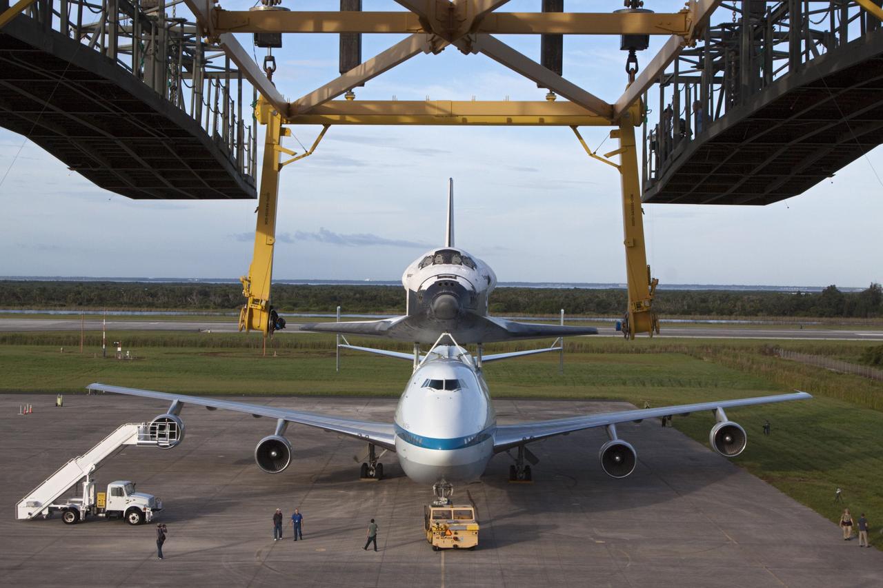 CAPE CANAVERAL, Fla. – Seen from the mate-demate device at the Shuttle Landing Facility at NASA's Kennedy Space Center in Florida, the space shuttle Endeavour, mounted atop NASA's Shuttle Carrier Aircraft, or SCA, has been rolled back in preparation for its ferry flight to California.      The SCA, a modified 747 jetliner, will fly Endeavour to Los Angeles where it will be placed on public display at the California Science Center. This is the final ferry flight scheduled in the Space Shuttle Program era. For more information on the shuttles' transition and retirement, visit http://www.nasa.gov/transition.  Photo credit: NASA/ Kim Shiflett