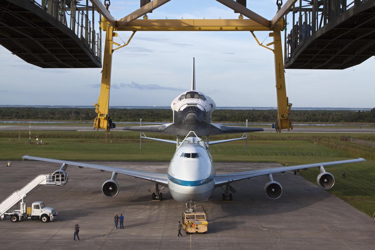 CAPE CANAVERAL, Fla. – Seen from the mate-demate device at the Shuttle Landing Facility at NASA's Kennedy Space Center in Florida, the space shuttle Endeavour, mounted atop NASA's Shuttle Carrier Aircraft, or SCA, has been rolled back in preparation for its ferry flight to California.      The SCA, a modified 747 jetliner, will fly Endeavour to Los Angeles where it will be placed on public display at the California Science Center. This is the final ferry flight scheduled in the Space Shuttle Program era. For more information on the shuttles' transition and retirement, visit http://www.nasa.gov/transition.  Photo credit: NASA/ Kim Shiflett