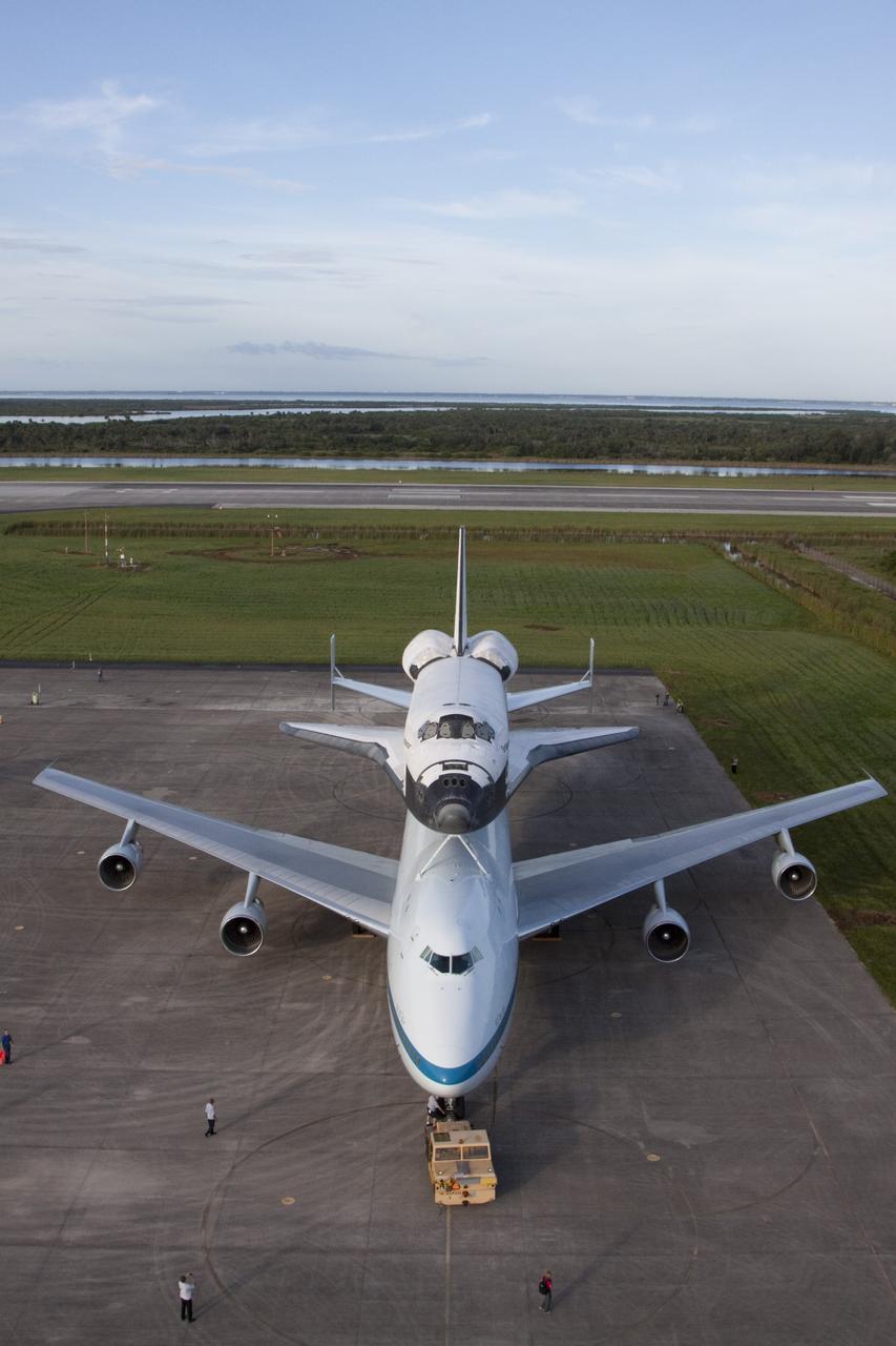 CAPE CANAVERAL, Fla. – Seen from the mate-demate device at the Shuttle Landing Facility at NASA's Kennedy Space Center in Florida, the space shuttle Endeavour, mounted atop NASA's Shuttle Carrier Aircraft, or SCA, has been rolled back in preparation for its ferry flight to California.      The SCA, a modified 747 jetliner, will fly Endeavour to Los Angeles where it will be placed on public display at the California Science Center. This is the final ferry flight scheduled in the Space Shuttle Program era. For more information on the shuttles' transition and retirement, visit http://www.nasa.gov/transition.  Photo credit: NASA/ Kim Shiflett