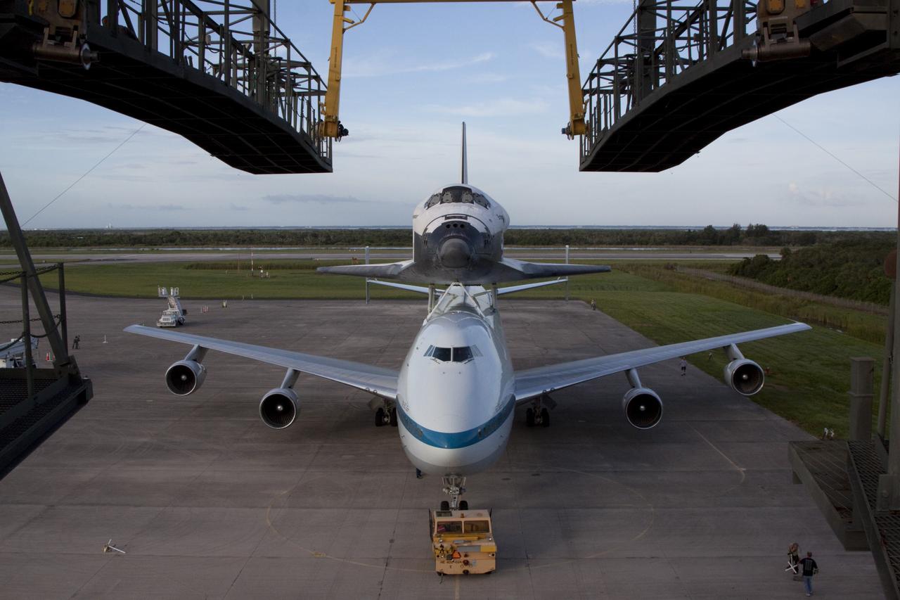 CAPE CANAVERAL, Fla. – Seen from the mate-demate device at the Shuttle Landing Facility at NASA's Kennedy Space Center in Florida, the space shuttle Endeavour, mounted atop NASA's Shuttle Carrier Aircraft, or SCA, has been rolled back in preparation for its ferry flight to California.      The SCA, a modified 747 jetliner, will fly Endeavour to Los Angeles where it will be placed on public display at the California Science Center. This is the final ferry flight scheduled in the Space Shuttle Program era. For more information on the shuttles' transition and retirement, visit http://www.nasa.gov/transition.  Photo credit: NASA/ Kim Shiflett