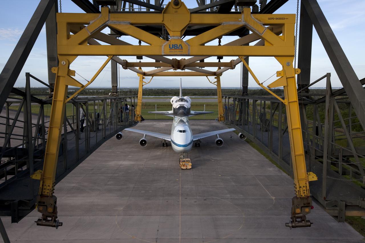 CAPE CANAVERAL, Fla. – Seen from the mate-demate device at the Shuttle Landing Facility at NASA's Kennedy Space Center in Florida, the space shuttle Endeavour, mounted atop NASA's Shuttle Carrier Aircraft, or SCA, has been rolled back in preparation for its ferry flight to California.      The SCA, a modified 747 jetliner, will fly Endeavour to Los Angeles where it will be placed on public display at the California Science Center. This is the final ferry flight scheduled in the Space Shuttle Program era. For more information on the shuttles' transition and retirement, visit http://www.nasa.gov/transition.  Photo credit: NASA/ Kim Shiflett