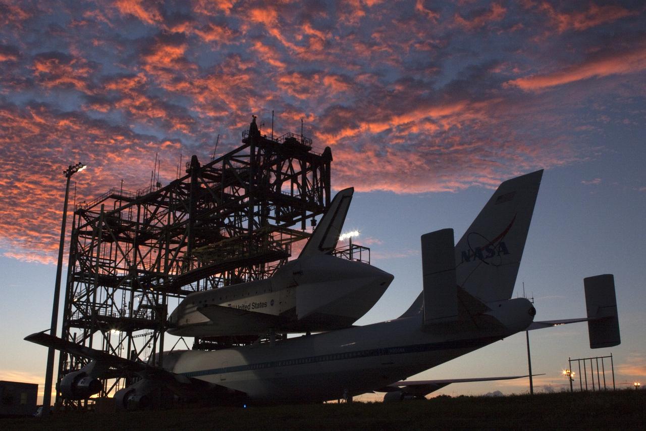 CAPE CANAVERAL, Fla. – Under a Florida sunrise at the Shuttle Landing Facility at NASA's Kennedy Space Center in Florida, the space shuttle Endeavour, mounted atop NASA's Shuttle Carrier Aircraft, or SCA, is prepared to roll back from the mate-demate device.      The SCA, a modified 747 jetliner, will fly Endeavour to Los Angeles where it will be placed on public display at the California Science Center. This is the final ferry flight scheduled in the Space Shuttle Program era. For more information on the shuttles' transition and retirement, visit http://www.nasa.gov/transition.  Photo credit: NASA/ Tim Jacobs