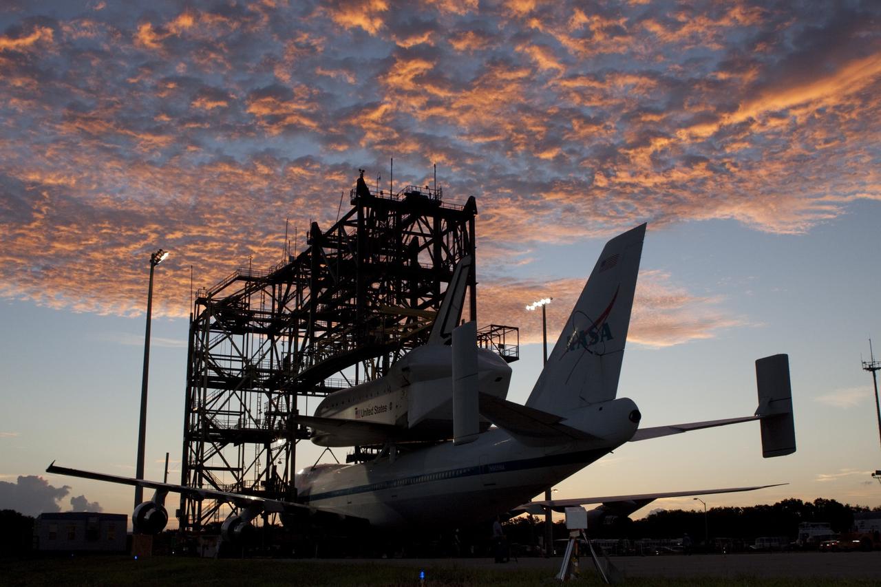 CAPE CANAVERAL, Fla. – Under a Florida sunrise at the Shuttle Landing Facility at NASA's Kennedy Space Center in Florida, the space shuttle Endeavour, mounted atop NASA's Shuttle Carrier Aircraft, or SCA, is prepared to roll back from the mate-demate device.      The SCA, a modified 747 jetliner, will fly Endeavour to Los Angeles where it will be placed on public display at the California Science Center. This is the final ferry flight scheduled in the Space Shuttle Program era. For more information on the shuttles' transition and retirement, visit http://www.nasa.gov/transition.  Photo credit: NASA/ Tim Jacobs