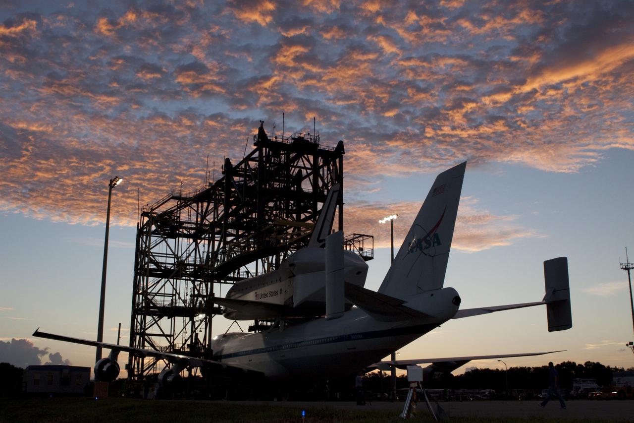 CAPE CANAVERAL, Fla. – Under a Florida sunrise at the Shuttle Landing Facility at NASA's Kennedy Space Center in Florida, the space shuttle Endeavour, mounted atop NASA's Shuttle Carrier Aircraft, or SCA, is prepared to roll back from the mate-demate device.      The SCA, a modified 747 jetliner, will fly Endeavour to Los Angeles where it will be placed on public display at the California Science Center. This is the final ferry flight scheduled in the Space Shuttle Program era. For more information on the shuttles' transition and retirement, visit http://www.nasa.gov/transition.  Photo credit: NASA/ Tim Jacobs