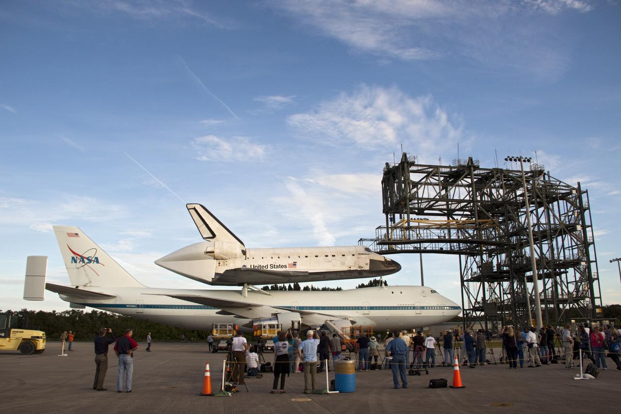 CAPE CANAVERAL, Fla. – At the Shuttle Landing Facility at NASA's Kennedy Space Center in Florida, members of the news media photograph the space shuttle Endeavour, mounted atop NASA's Shuttle Carrier Aircraft, or SCA, as it rolls back from the mate-demate device.      The SCA, a modified 747 jetliner, will fly Endeavour to Los Angeles where it will be placed on public display at the California Science Center. This is the final ferry flight scheduled in the Space Shuttle Program era. For more information on the shuttles' transition and retirement, visit http://www.nasa.gov/transition.  Photo credit: NASA/ Tim Jacobs