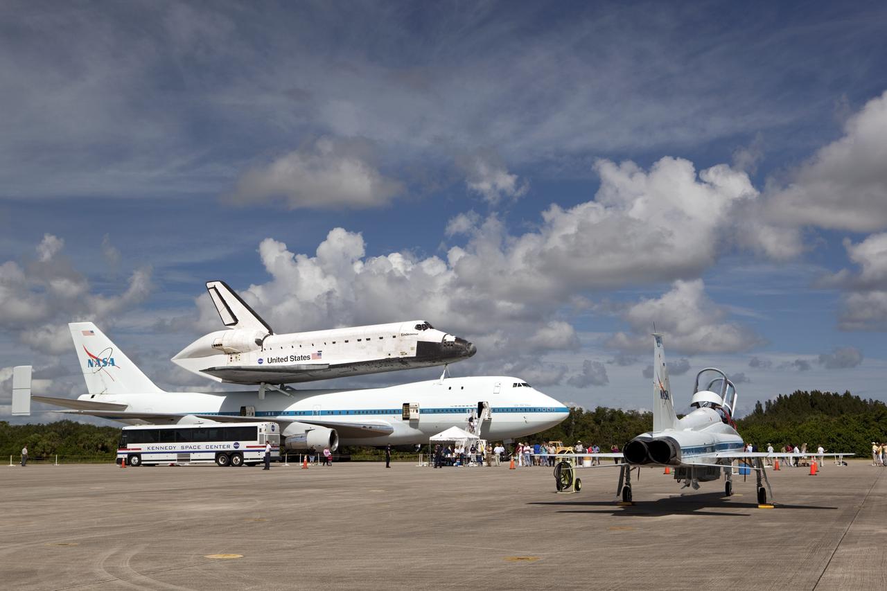 CAPE CANAVERAL, Fla. – At the Shuttle Landing Facility at NASA's Kennedy Space Center in Florida, the space shuttle Endeavour, mounted atop NASA's Shuttle Carrier Aircraft, or SCA, has rolled back from the mate-demate device in preparation for its ferry flight to California. In the foreground is a NASA T-38 jet.      The SCA, a modified 747 jetliner, will fly Endeavour to Los Angeles where it will be placed on public display at the California Science Center. This is the final ferry flight scheduled in the Space Shuttle Program era. For more information on the shuttles' transition and retirement, visit http://www.nasa.gov/transition.  Photo credit: NASA/ Dimitri Gerondidakis