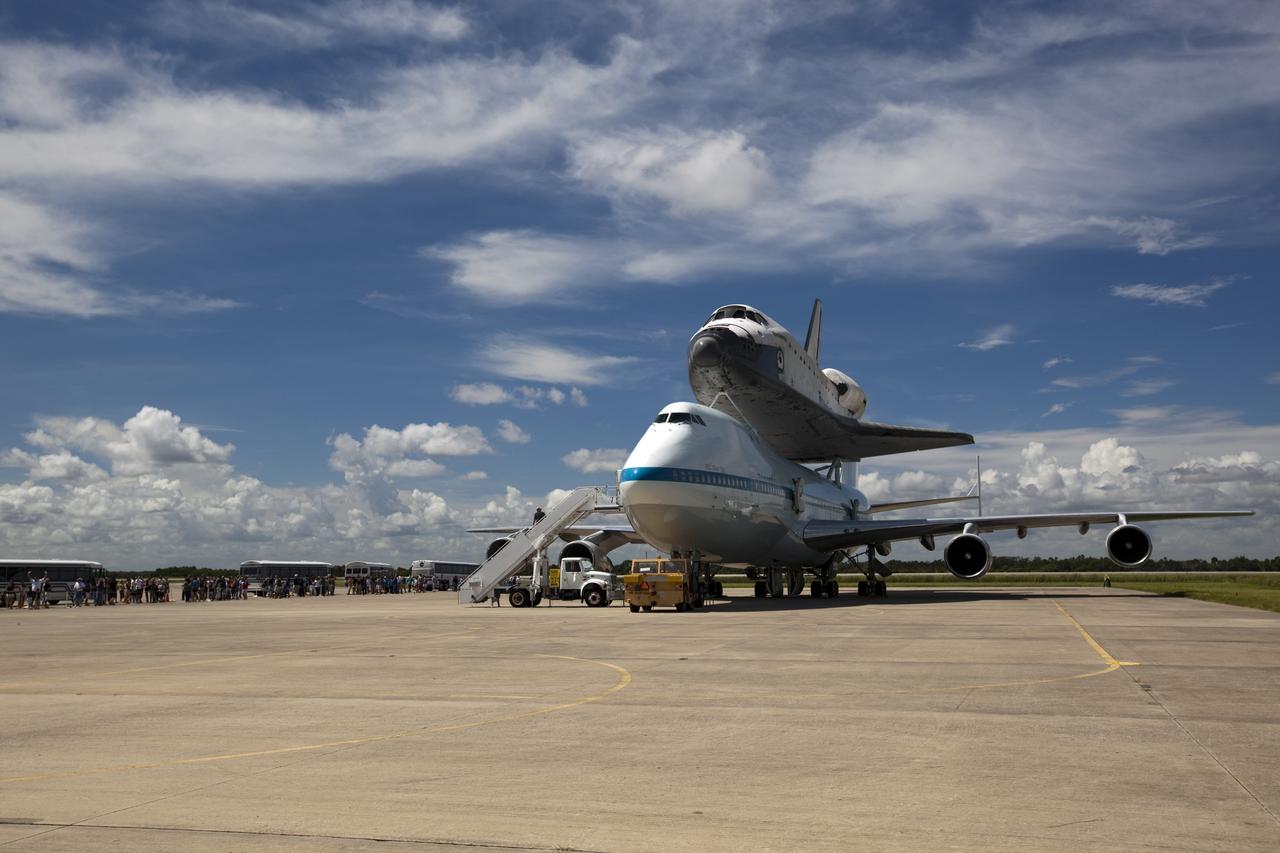 CAPE CANAVERAL, Fla. – At the Shuttle Landing Facility at NASA's Kennedy Space Center in Florida, guests arrive by bus to view the space shuttle Endeavour, mounted atop NASA's Shuttle Carrier Aircraft, or SCA, as preparations continue for the ferry flight to California.      The SCA, a modified 747 jetliner, will fly Endeavour to Los Angeles where it will be placed on public display at the California Science Center. This is the final ferry flight scheduled in the Space Shuttle Program era. For more information on the shuttles' transition and retirement, visit http://www.nasa.gov/transition.  Photo credit: NASA/ Dimitri Gerondidakis