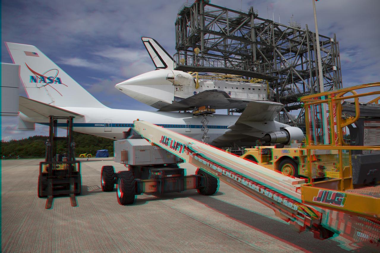 CAPE CANAVERAL, Fla. – This three-dimensional view at the Shuttle Landing Facility at NASA's Kennedy Space Center in Florida, shows a lift being used to support the space shuttle Endeavour, mounted atop NASA's Shuttle Carrier Aircraft, or SCA, as it was being prepared for its ferry flight to California.  This image may be viewed in 3-D with red and blue glasses.      The SCA, a modified 747 jetliner, will fly Endeavour to Los Angeles where it will be placed on public display at the California Science Center. This is the final ferry flight scheduled in the Space Shuttle Program era. For more information on the shuttles' transition and retirement, visit http://www.nasa.gov/transition.  Photo credit: NASA/ Frankie Martin