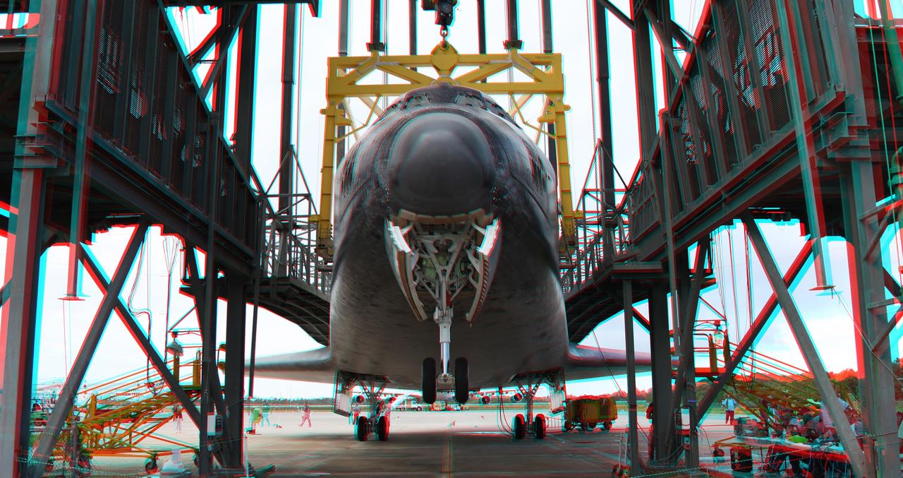 CAPE CANAVERAL, Fla. – This three -dimensional view at the Shuttle Landing Facility at NASA's Kennedy Space Center in Florida, shows the space shuttle Endeavour as it is being lifted in the mate-demate devise for mating to the NASA Shuttle Carrier Aircraft, or SCA, which will ferry the orbiter to California.  This image may be viewed in 3-D with red and blue glasses.      The SCA, a modified 747 jetliner, will fly Endeavour to Los Angeles where it will be placed on public display at the California Science Center. This is the final ferry flight scheduled in the Space Shuttle Program era. For more information on the shuttles' transition and retirement, visit http://www.nasa.gov/transition.  Photo credit: NASA/ Frankie Martin