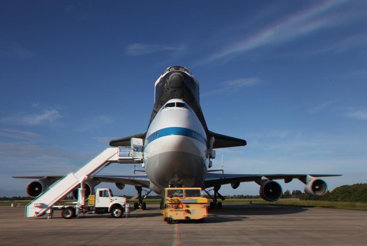 CAPE CANAVERAL, Fla. – This three -dimensional view at the Shuttle Landing Facility at NASA's Kennedy Space Center in Florida, shows the space shuttle Endeavour, mounted atop NASA's Shuttle Carrier Aircraft, or SCA, as it is being prepared for its ferry flight to California.  This image may be viewed in 3-D with red and blue glasses.      The SCA, a modified 747 jetliner, will fly Endeavour to Los Angeles where it will be placed on public display at the California Science Center. This is the final ferry flight scheduled in the Space Shuttle Program era. For more information on the shuttles' transition and retirement, visit http://www.nasa.gov/transition.  Photo credit: NASA/ Frankie Martin
