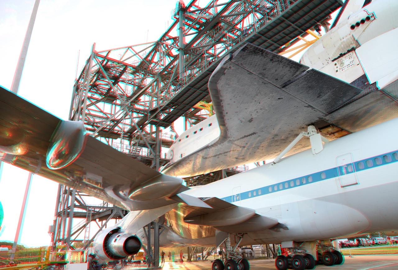 CAPE CANAVERAL, Fla. – This three -dimensional view at the Shuttle Landing Facility at NASA's Kennedy Space Center in Florida, shows the space shuttle Endeavour, being mounted atop NASA's Shuttle Carrier Aircraft, or SCA, in the mate-demate device.  This image may be viewed in 3-D with red and blue glasses.      The SCA, a modified 747 jetliner, will fly Endeavour to Los Angeles where it will be placed on public display at the California Science Center. This is the final ferry flight scheduled in the Space Shuttle Program era. For more information on the shuttles' transition and retirement, visit http://www.nasa.gov/transition.  Photo credit: NASA/ Frankie Martin