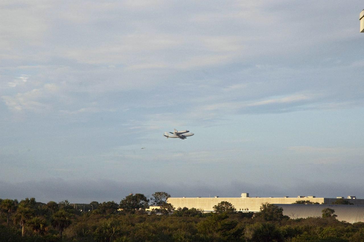 CAPE CANAVERAL, Fla. – Space shuttle Endeavour flies over the solid rocket booster Assembly and Refurbishment Facility in Launch Complex 39 as it departs from NASA's Kennedy Space Center in Florida at 7:22 a.m. EDT on the back of NASA's Shuttle Carrier Aircraft, or SCA. The SCA, a modified 747 jetliner, will fly Endeavour to Houston and then to Los Angeles where it will be placed on public display at the California Science Center. This is the final ferry flight scheduled in the Space Shuttle Program era. For more information on the shuttles' transition and retirement, visit http://www.nasa.gov/transition. Photo credit: NASA/Debbie Odom
