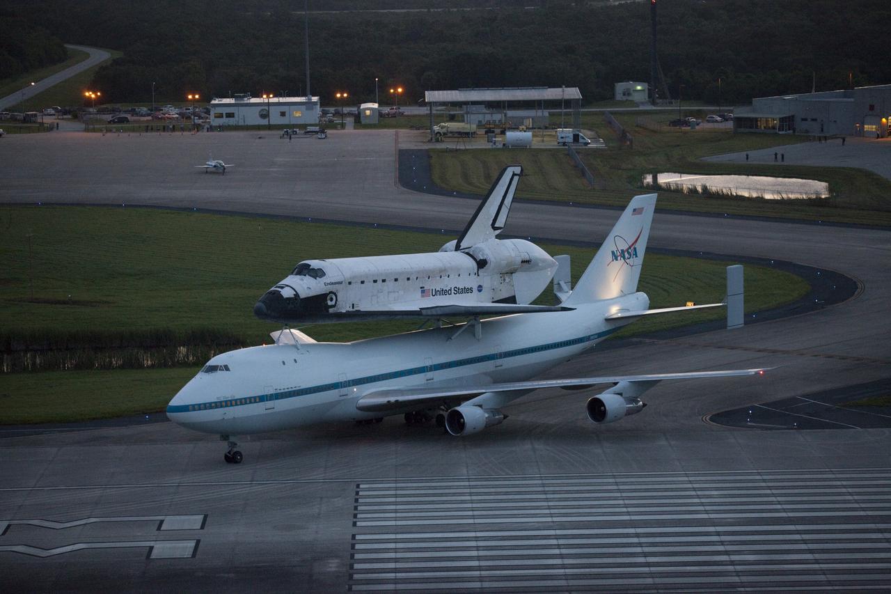 CAPE CANAVERAL, Fla. – At the Shuttle Landing Facility at NASA's Kennedy Space Center in Florida, NASA's Shuttle Carrier Aircraft, or SCA, with the space shuttle Endeavour mounted atop, taxis on to the runway for its ferry flight to California.    The SCA, a modified 747 jetliner, will fly Endeavour to Los Angeles where it will be placed on public display at the California Science Center. This is the final ferry flight scheduled in the Space Shuttle Program era. For more information on the shuttles' transition and retirement, visit http://www.nasa.gov/transition.  Photo credit: NASA/Kim Shiflett