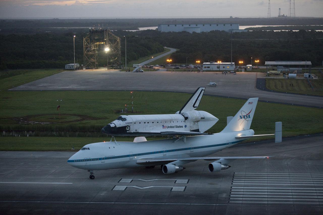 CAPE CANAVERAL, Fla. – At the Shuttle Landing Facility at NASA's Kennedy Space Center in Florida, NASA's Shuttle Carrier Aircraft, or SCA, with the space shuttle Endeavour mounted atop, taxis on to the runway for its ferry flight to California.    The SCA, a modified 747 jetliner, will fly Endeavour to Los Angeles where it will be placed on public display at the California Science Center. This is the final ferry flight scheduled in the Space Shuttle Program era. For more information on the shuttles' transition and retirement, visit http://www.nasa.gov/transition.  Photo credit: NASA/Kim Shiflett