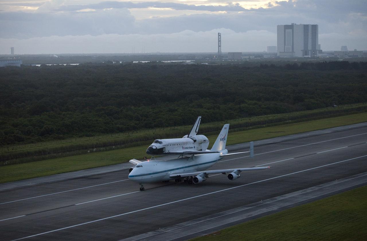 CAPE CANAVERAL, Fla. – At the Shuttle Landing Facility at NASA's Kennedy Space Center in Florida, NASA's Shuttle Carrier Aircraft, or SCA, with the space shuttle Endeavour mounted atop, taxis down the runway for its ferry flight to California. The Vehicle Assembly Building can be seen in the background.    The SCA, a modified 747 jetliner, will fly Endeavour to Los Angeles where it will be placed on public display at the California Science Center. This is the final ferry flight scheduled in the Space Shuttle Program era. For more information on the shuttles' transition and retirement, visit http://www.nasa.gov/transition.  Photo credit: NASA/Kim Shiflett