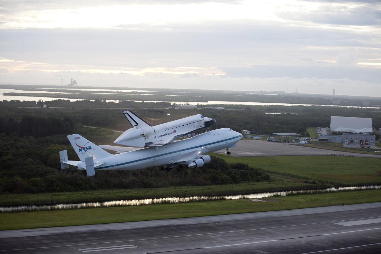 CAPE CANAVERAL, Fla. – Space shuttle Endeavour takes to the sky over the Shuttle Landing Facility at NASA's Kennedy Space Center in Florida at 7:22 a.m. EDT mounted atop NASA's Shuttle Carrier Aircraft, or SCA. In the distance is Launch Pad 39A, the starting point for many space shuttle missions. The SCA, a modified 747 jetliner, will fly Endeavour to Houston and then to Los Angeles where it will be placed on public display at the California Science Center. This is the final ferry flight scheduled in the Space Shuttle Program era. For more information on the shuttles' transition and retirement, visit http://www.nasa.gov/transition. Photo credit: NASA/Kim Shiflett