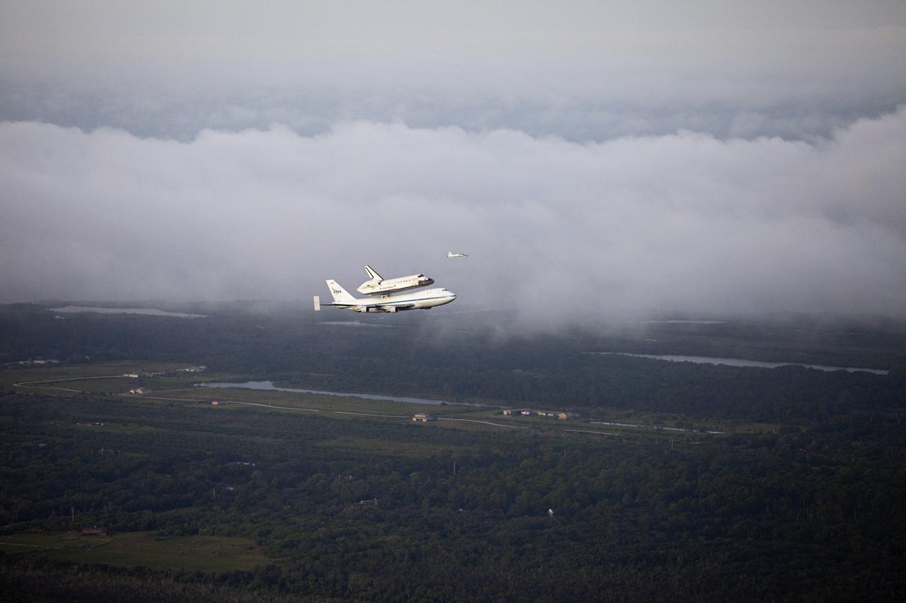 CAPE CANAVERAL, Fla. – Space shuttle Endeavour takes to the clouds over the Shuttle Landing Facility at NASA's Kennedy Space Center in Florida at 7:22 a.m. EDT mounted atop NASA's Shuttle Carrier Aircraft, or SCA.    The SCA, a modified 747 jetliner, will fly Endeavour to Los Angeles where it will be placed on public display at the California Science Center. This is the final ferry flight scheduled in the Space Shuttle Program era. For more information on the shuttles' transition and retirement, visit http://www.nasa.gov/transition.  Photo credit: NASA/Kim Shiflett