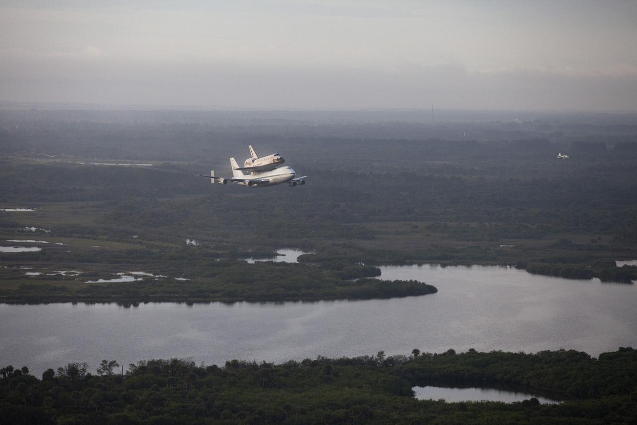 CAPE CANAVERAL, Fla. – Space shuttle Endeavour soars away from the Shuttle Landing Facility at NASA's Kennedy Space Center in Florida at 7:22 a.m. EDT mounted atop NASA's Shuttle Carrier Aircraft, or SCA.    The SCA, a modified 747 jetliner, will fly Endeavour to Los Angeles where it will be placed on public display at the California Science Center. This is the final ferry flight scheduled in the Space Shuttle Program era. For more information on the shuttles' transition and retirement, visit http://www.nasa.gov/transition.  Photo credit: NASA/Kim Shiflett