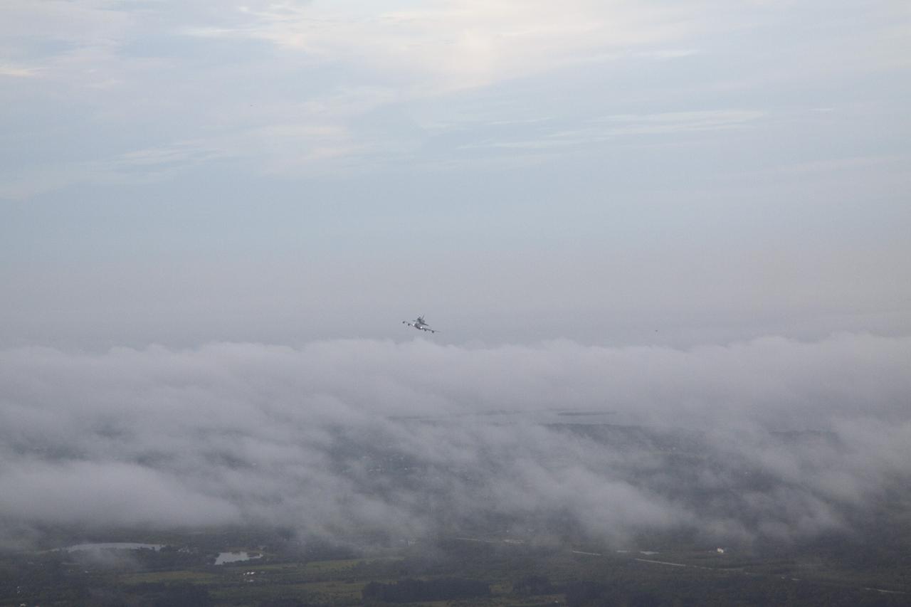 CAPE CANAVERAL, Fla. – Space shuttle Endeavour, mounted atop NASA's Shuttle Carrier Aircraft or SCA, rises above the clouds over the Shuttle Landing Facility at NASA's Kennedy Space Center in Florida at 7:22 a.m. EDT.     The SCA, a modified 747 jetliner, will fly Endeavour to Los Angeles where it will be placed on public display at the California Science Center. This is the final ferry flight scheduled in the Space Shuttle Program era. For more information on the shuttles' transition and retirement, visit http://www.nasa.gov/transition.  Photo credit: NASA/Kim Shiflett