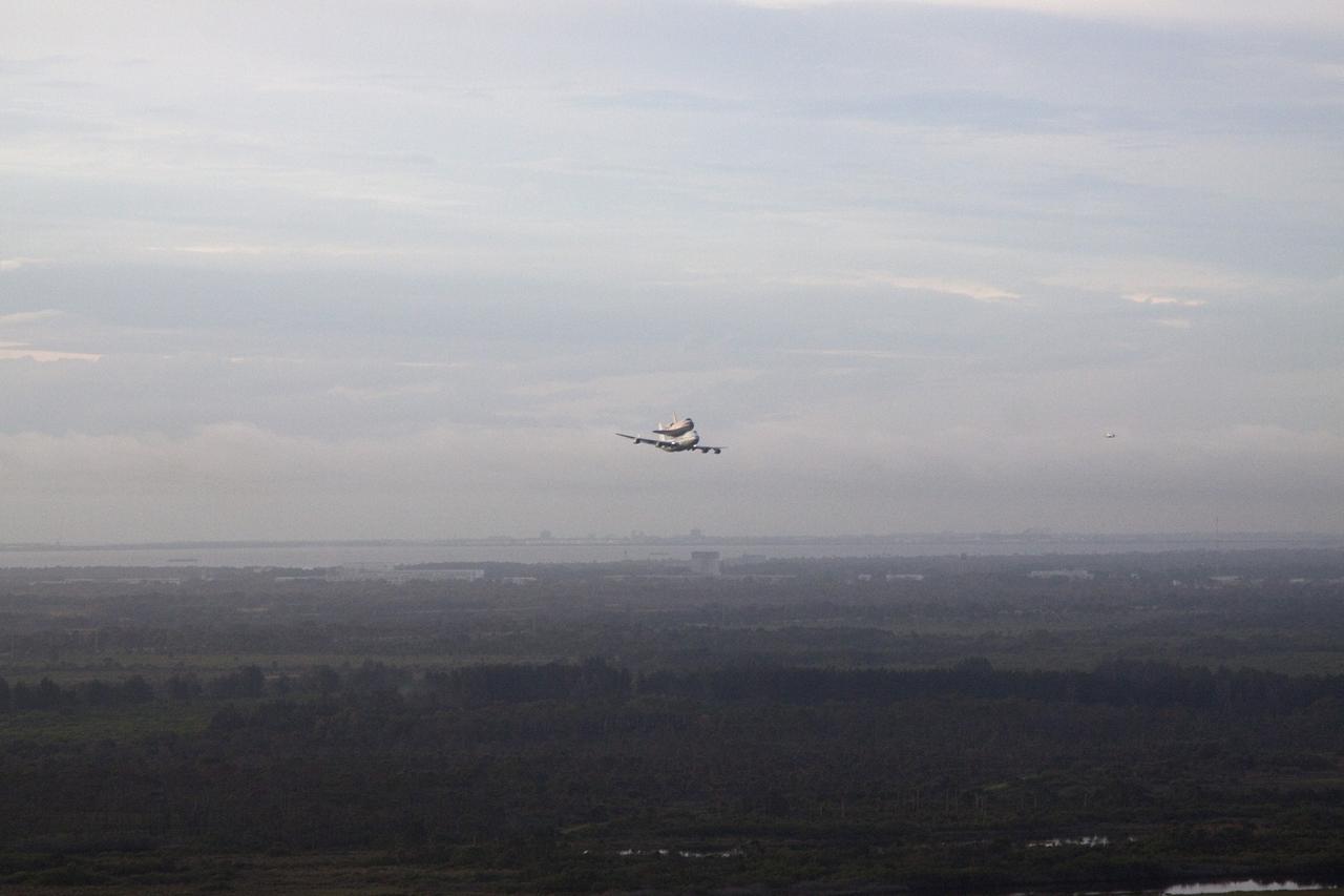 CAPE CANAVERAL, Fla. – Space shuttle Endeavour, mounted atop NASA's Shuttle Carrier Aircraft or SCA, makes a low pass over NASA's Kennedy Space Center in Florida following its takeoff from the Shuttle Landing Facility at 7:22 a.m. EDT.    The SCA, a modified 747 jetliner, will fly Endeavour to Los Angeles where it will be placed on public display at the California Science Center. This is the final ferry flight scheduled in the Space Shuttle Program era. For more information on the shuttles' transition and retirement, visit http://www.nasa.gov/transition.  Photo credit: NASA/Kim Shiflett