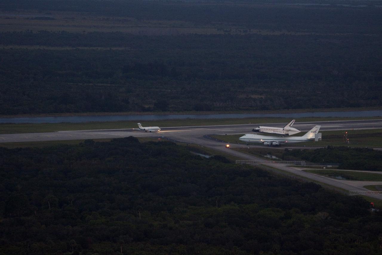 CAPE CANAVERAL, Fla. – At the Shuttle Landing Facility at NASA's Kennedy Space Center in Florida, NASA's Shuttle Carrier Aircraft, or SCA, with the space shuttle Endeavour mounted atop, taxis down the runway for its ferry flight to California. Already on the runway is the pathfinder aircraft.      The SCA, a modified 747 jetliner, will fly Endeavour to Los Angeles where it will be placed on public display at the California Science Center. This is the final ferry flight scheduled in the Space Shuttle Program era. For more information on the shuttles' transition and retirement, visit http://www.nasa.gov/transition.  Photo credit: NASA/Jim Grossmann