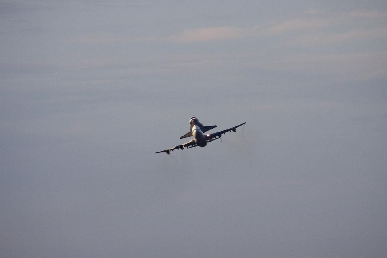 CAPE CANAVERAL, Fla. – At NASA's Kennedy Space Center in Florida, NASA's Shuttle Carrier Aircraft, or SCA, with the space shuttle Endeavour mounted atop, prepares to make a low-level pass over the Shuttle Landing Facility. The shuttle-SCA combination will then head west for its ferry flight to California. The SCA, a modified 747 jetliner, will fly Endeavour to Los Angeles where it will be placed on public display at the California Science Center. This is the final ferry flight scheduled in the Space Shuttle Program era. For more information on the shuttles' transition and retirement, visit http://www.nasa.gov/transition. Photo credit: NASA/Jim Grossmann