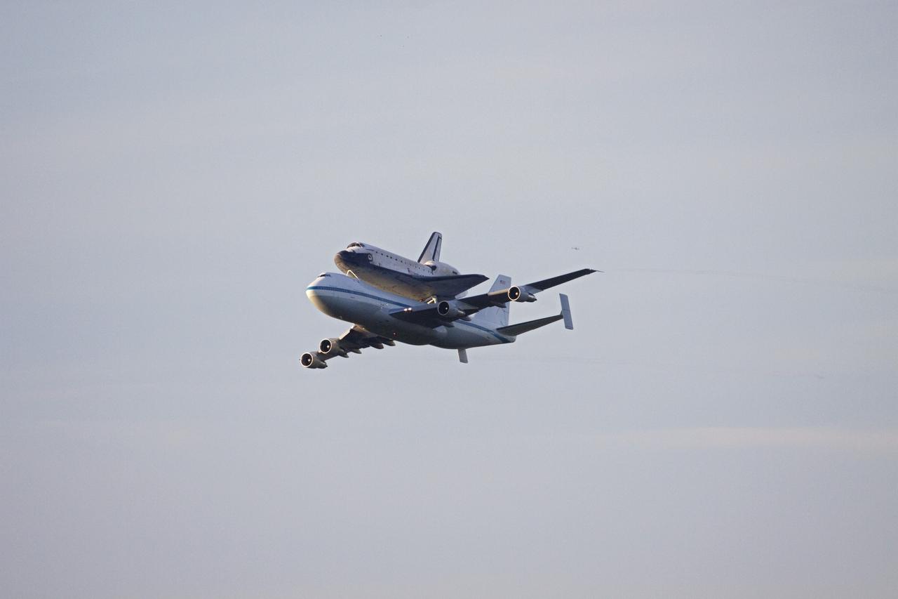 CAPE CANAVERAL, Fla. – At NASA's Kennedy Space Center in Florida, NASA's Shuttle Carrier Aircraft, or SCA, with the space shuttle Endeavour mounted atop, prepares to make a low-level pass over the Shuttle Landing Facility. The shuttle-SCA combination will then head west for its ferry flight to California.      The SCA, a modified 747 jetliner, will fly Endeavour to Los Angeles where it will be placed on public display at the California Science Center. This is the final ferry flight scheduled in the Space Shuttle Program era. For more information on the shuttles' transition and retirement, visit http://www.nasa.gov/transition.  Photo credit: NASA/Jim Grossmann