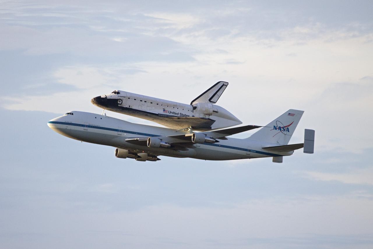 CAPE CANAVERAL, Fla. – At NASA's Kennedy Space Center in Florida, NASA's Shuttle Carrier Aircraft, or SCA, with the space shuttle Endeavour mounted atop, prepares to make a low-level pass over the Shuttle Landing Facility. The shuttle-SCA combination will then head west for its ferry flight to California. The SCA, a modified 747 jetliner, will fly Endeavour to Los Angeles where it will be placed on public display at the California Science Center. This is the final ferry flight scheduled in the Space Shuttle Program era. For more information on the shuttles' transition and retirement, visit http://www.nasa.gov/transition. Photo credit: NASA/Jim Grossmann