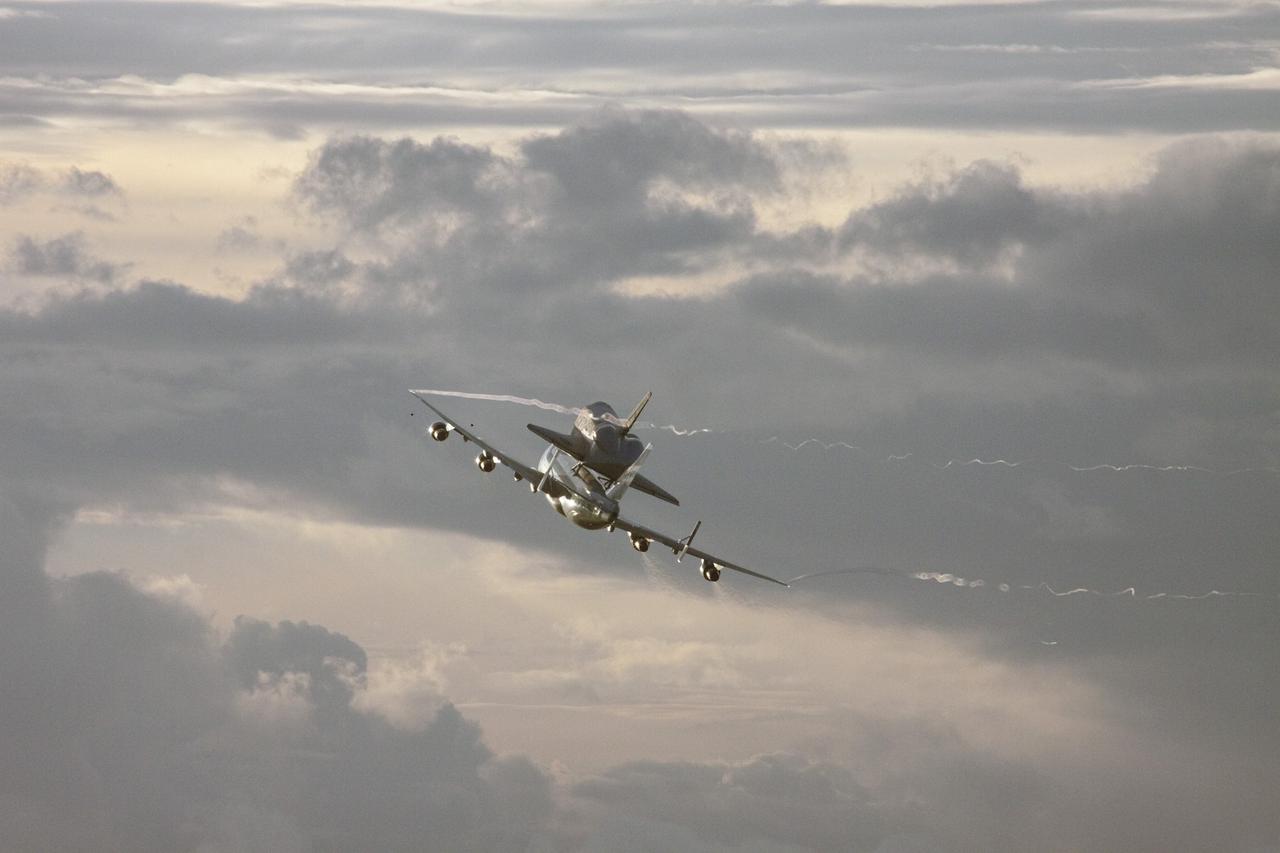 CAPE CANAVERAL, Fla. – At NASA's Kennedy Space Center in Florida, NASA's Shuttle Carrier Aircraft, or SCA, with the space shuttle Endeavour mounted atop, prepares to make a low-level pass over the Shuttle Landing Facility. The shuttle-SCA combination will then head west for its ferry flight to California. The SCA, a modified 747 jetliner, will fly Endeavour to Los Angeles where it will be placed on public display at the California Science Center. This is the final ferry flight scheduled in the Space Shuttle Program era. For more information on the shuttles' transition and retirement, visit http://www.nasa.gov/transition. Photo credit: NASA/Jim Grossmann