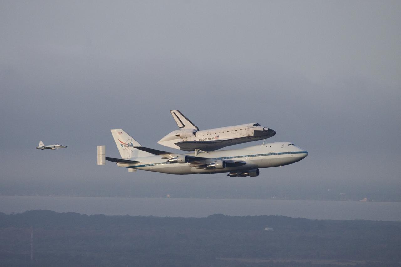 CAPE CANAVERAL, Fla. – At NASA's Kennedy Space Center in Florida, NASA's Shuttle Carrier Aircraft, or SCA, with the space shuttle Endeavour mounted atop, makes a low-level pass over the Shuttle Landing Facility. Following behind the SCA-shuttle combination is a T-38 chase aircraft. After making several low-level passes over several locations on Florida's Space Coast the SCA-Shuttle will head west for its ferry flight to California.      The SCA, a modified 747 jetliner, will fly Endeavour to Los Angeles where it will be placed on public display at the California Science Center. This is the final ferry flight scheduled in the Space Shuttle Program era. For more information on the shuttles' transition and retirement, visit http://www.nasa.gov/transition.  Photo credit: NASA/Jim Grossmann
