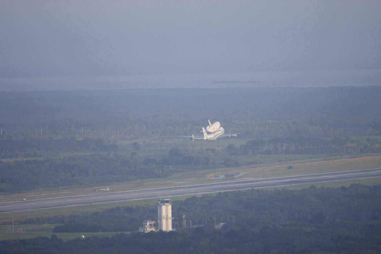 CAPE CANAVERAL, Fla. – At NASA's Kennedy Space Center in Florida, NASA's Shuttle Carrier Aircraft, or SCA, with the space shuttle Endeavour mounted atop, makes a low-level pass over the Shuttle Landing Facility. Following behind the SCA-shuttle combination is a T-38 chase aircraft. After making several low-level passes over several locations on Florida's Space Coast the SCA-Shuttle will head west for its ferry flight to California.      The SCA, a modified 747 jetliner, will fly Endeavour to Los Angeles where it will be placed on public display at the California Science Center. This is the final ferry flight scheduled in the Space Shuttle Program era. For more information on the shuttles' transition and retirement, visit http://www.nasa.gov/transition.  Photo credit: NASA/Jim Grossmann