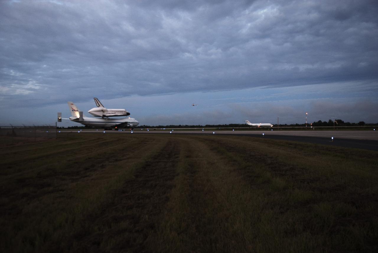 CAPE CANAVERAL, Fla. – At the Shuttle Landing Facility at NASA's Kennedy Space Center in Florida, with a pathfinder aircraft in front, NASA's Shuttle Carrier Aircraft, or SCA, with the space shuttle Endeavour mounted atop, taxis on the runway for its ferry flight to California. The SCA, a modified 747 jetliner, will fly Endeavour to Los Angeles where it will be placed on public display at the California Science Center. This is the final ferry flight scheduled in the Space Shuttle Program era. For more information on the shuttles' transition and retirement, visit http://www.nasa.gov/transition. Photo credit: NASA/George Sampson