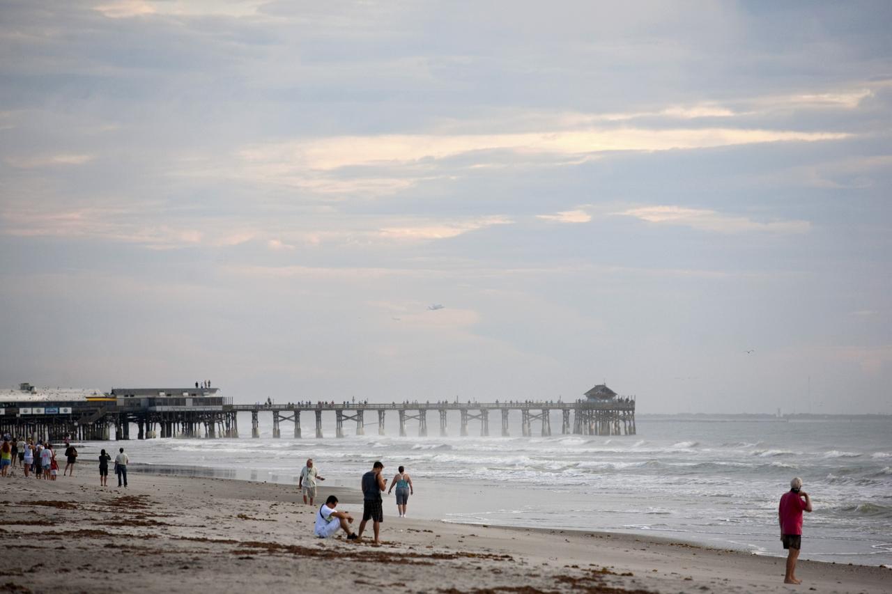 COCOA BEACH, Fla. – People lined the shore along Cocoa Beach to get an early-morning view of NASA's Shuttle Carrier Aircraft, or SCA, with the space shuttle Endeavour mounted atop. The SCA, a modified 747 jetliner, will fly Endeavour to Los Angeles where it will be placed on public display at the California Science Center. This is the final ferry flight scheduled in the Space Shuttle Program era. For more information on the shuttles' transition and retirement, visit http://www.nasa.gov/transition. Photo credit: NASA/Alan Ault