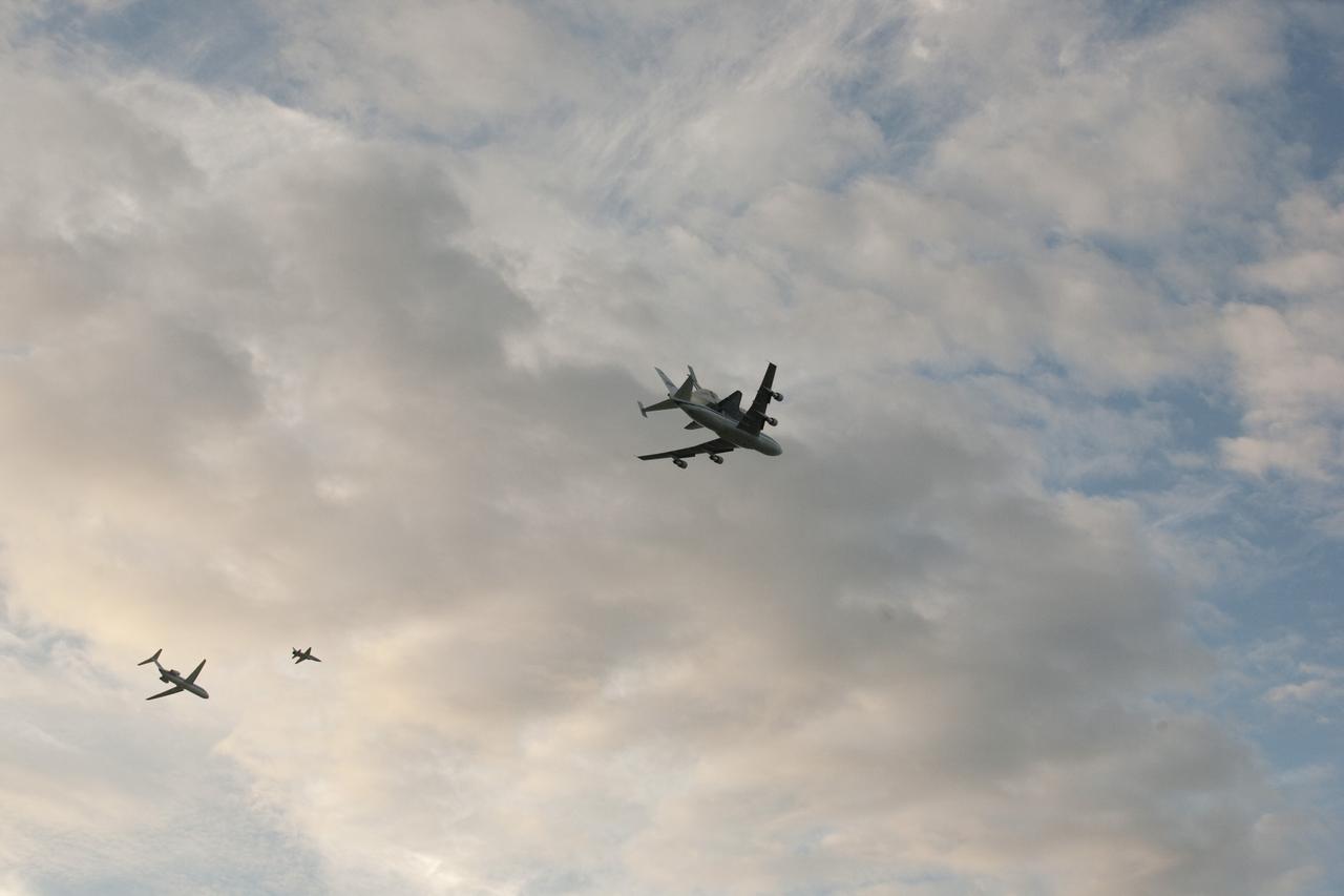 COCOA BEACH, Fla. – NASA's Shuttle Carrier Aircraft, or SCA, with the space shuttle Endeavour mounted atop, right, is accompanied by a T-38 chase aircraft, center, and a pathfinder aircraft flying along Cocoa Beach. The SCA, a modified 747 jetliner, will fly Endeavour to Los Angeles where it will be placed on public display at the California Science Center. This is the final ferry flight scheduled in the Space Shuttle Program era. For more information on the shuttles' transition and retirement, visit http://www.nasa.gov/transition. Photo credit: NASA/Alan Ault