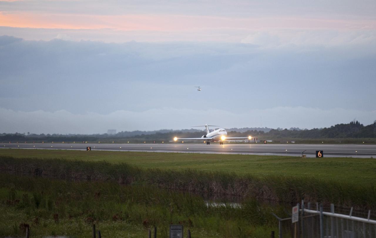 CAPE CANAVERAL, Fla. – As a NASA helicopter hovers overhead, a pathfinder aircraft takes off from the Shuttle Landing Facility at NASA's Kennedy Space Center in Florida. The pathfinder will fly in front of NASA's Shuttle Carrier Aircraft, or SCA, with the space shuttle Endeavour mounted atop, during its ferry flight to California. The SCA, a modified 747 jetliner, will fly Endeavour to Los Angeles where it will be placed on public display at the California Science Center. This is the final ferry flight scheduled in the Space Shuttle Program era. For more information on the shuttles' transition and retirement, visit http://www.nasa.gov/transition. Photo credit: NASA/Frankie Martin
