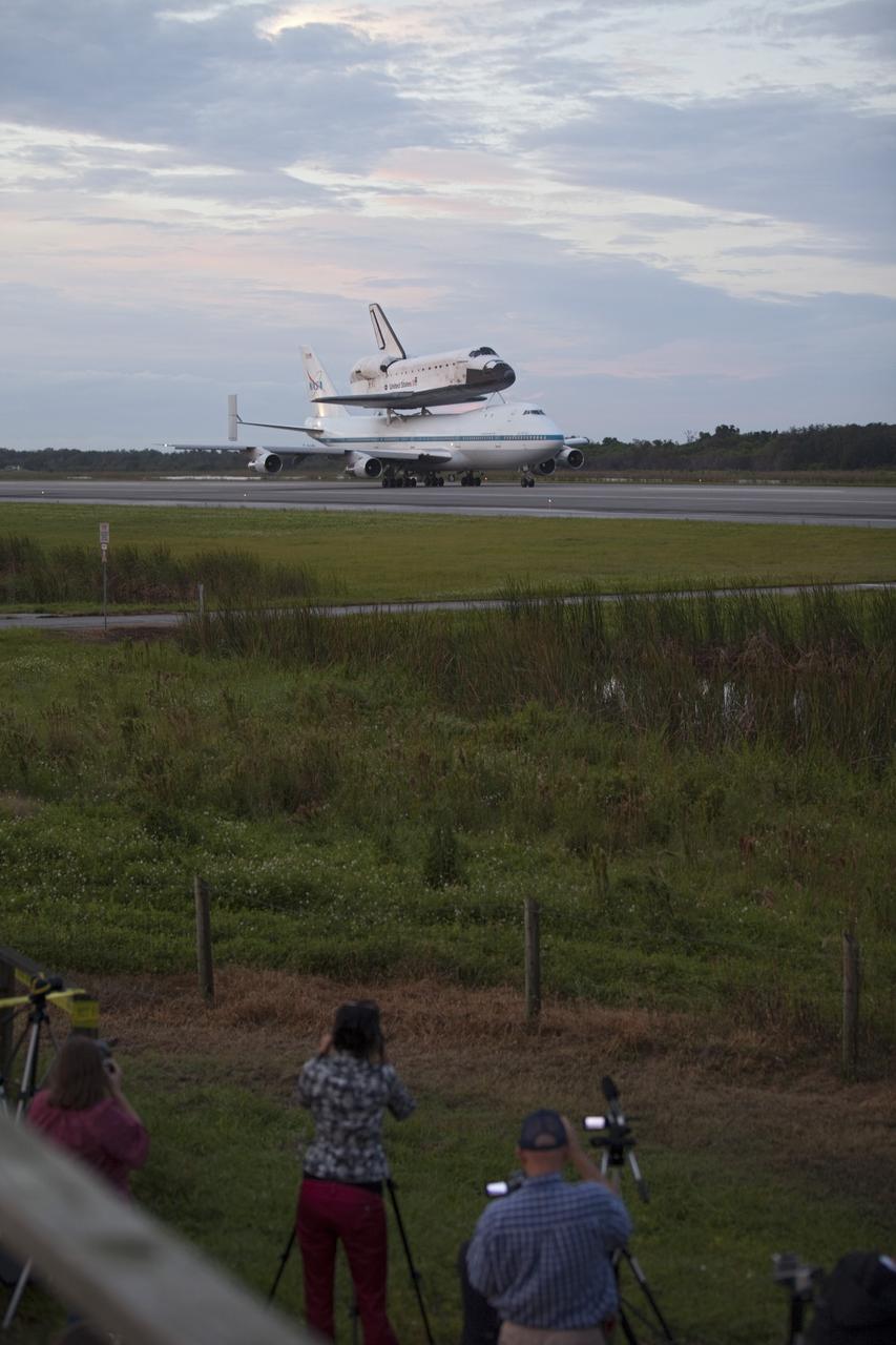 CAPE CANAVERAL, Fla. – At the Shuttle Landing Facility at NASA's Kennedy Space Center in Florida, photographers record NASA's Shuttle Carrier Aircraft, or SCA, with the space shuttle Endeavour mounted atop, as it taxis on the runway for its ferry flight to California. The SCA, a modified 747 jetliner, will fly Endeavour to Los Angeles where it will be placed on public display at the California Science Center. This is the final ferry flight scheduled in the Space Shuttle Program era. For more information on the shuttles' transition and retirement, visit http://www.nasa.gov/transition. Photo credit: NASA/Frankie Martin