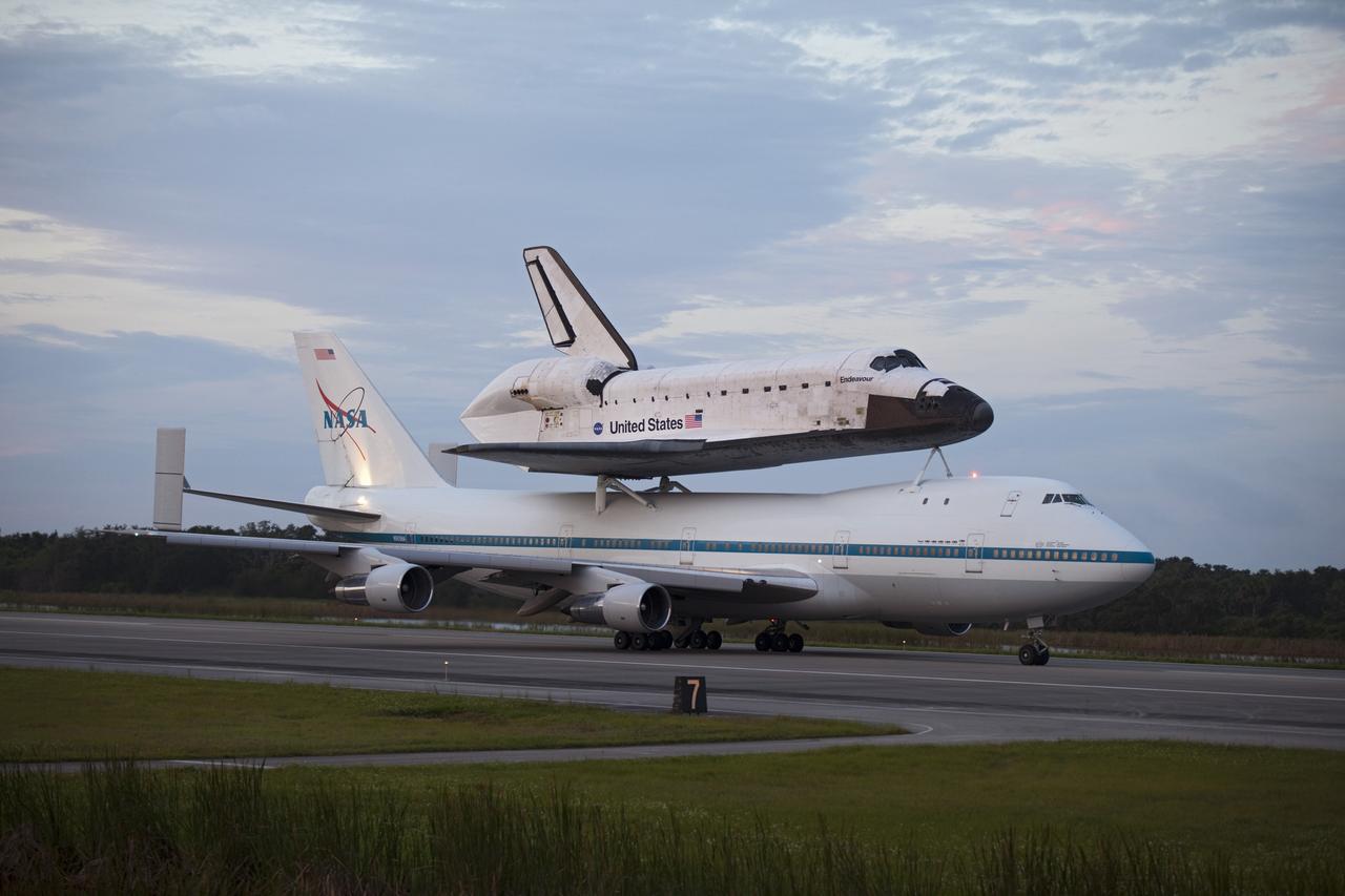 CAPE CANAVERAL, Fla. – At the Shuttle Landing Facility at NASA's Kennedy Space Center in Florida, NASA's Shuttle Carrier Aircraft, or SCA, with the space shuttle Endeavour mounted atop, taxis on the runway for its ferry flight to California. The SCA, a modified 747 jetliner, will fly Endeavour to Los Angeles where it will be placed on public display at the California Science Center. This is the final ferry flight scheduled in the Space Shuttle Program era. For more information on the shuttles' transition and retirement, visit http://www.nasa.gov/transition. Photo credit: NASA/Frankie Martin