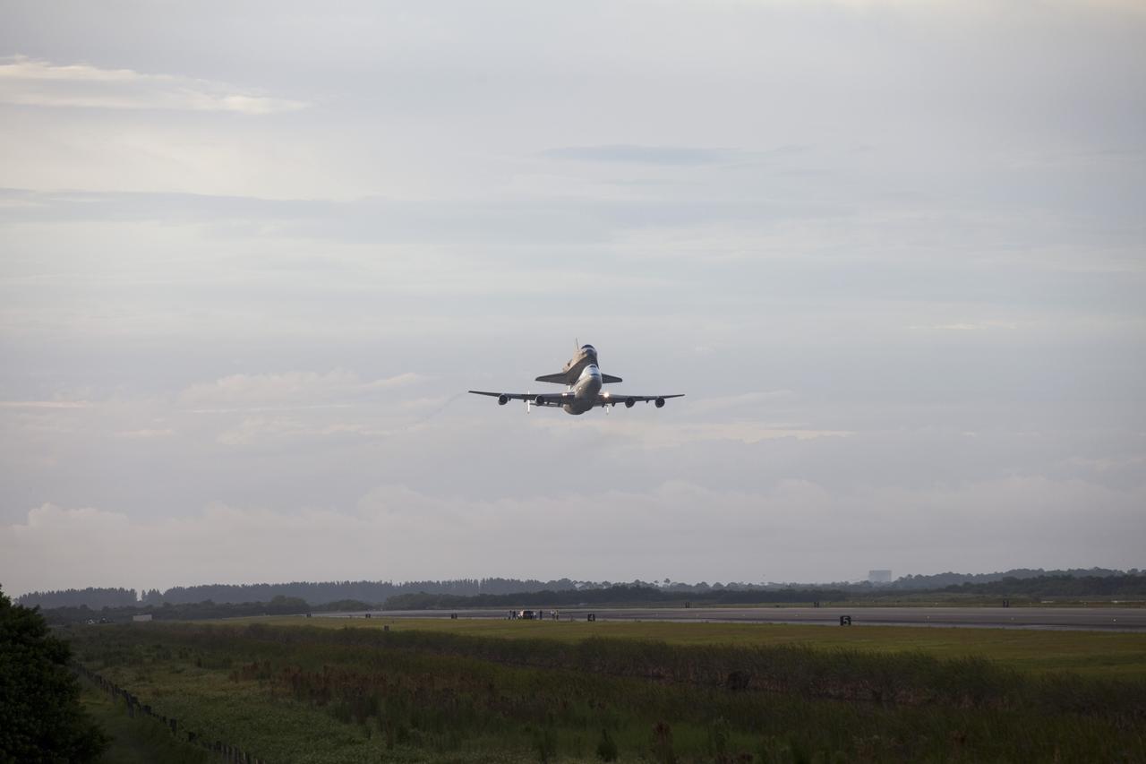 CAPE CANAVERAL, Fla. – At the Shuttle Landing Facility at NASA's Kennedy Space Center in Florida, NASA's Shuttle Carrier Aircraft, or SCA, with the space shuttle Endeavour mounted atop, makes a low-level pass as it begins its ferry flight to California. The SCA, a modified 747 jetliner, will fly Endeavour to Los Angeles where it will be placed on public display at the California Science Center. This is the final ferry flight scheduled in the Space Shuttle Program era. For more information on the shuttles' transition and retirement, visit http://www.nasa.gov/transition. Photo credit: NASA/Frankie Martin