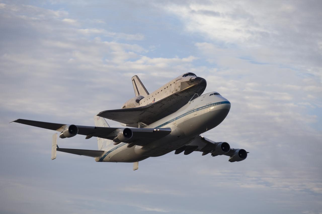 CAPE CANAVERAL, Fla. – At the Shuttle Landing Facility at NASA's Kennedy Space Center in Florida, NASA's Shuttle Carrier Aircraft, or SCA, with the space shuttle Endeavour mounted atop, makes a low-level pass as it begins its ferry flight to California. The SCA, a modified 747 jetliner, will fly Endeavour to Los Angeles where it will be placed on public display at the California Science Center. This is the final ferry flight scheduled in the Space Shuttle Program era. For more information on the shuttles' transition and retirement, visit http://www.nasa.gov/transition. Photo credit: NASA/Frankie Martin