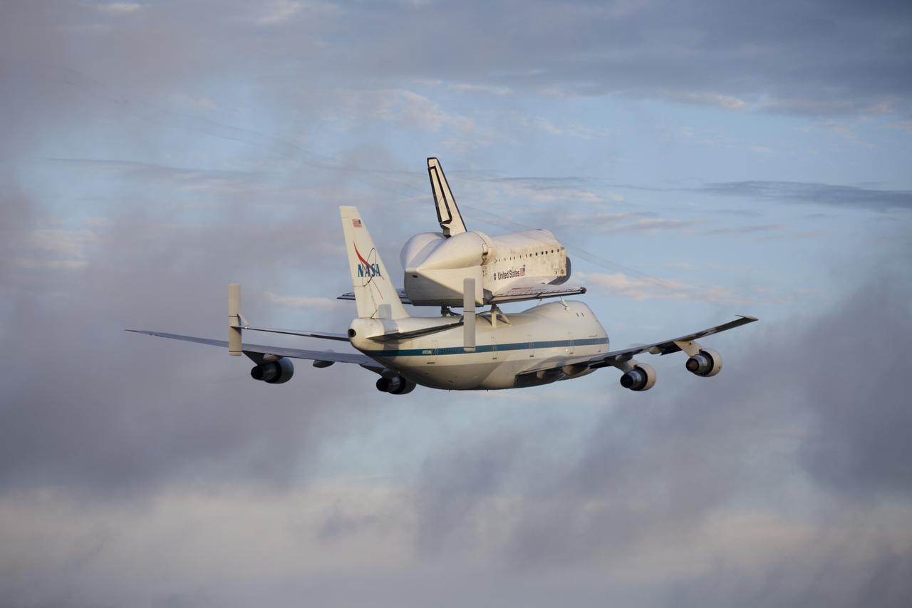 CAPE CANAVERAL, Fla. – At the Shuttle Landing Facility at NASA's Kennedy Space Center in Florida, NASA's Shuttle Carrier Aircraft, or SCA, with the space shuttle Endeavour mounted atop, makes a low-level pass as it begins its ferry flight to California. The SCA, a modified 747 jetliner, will fly Endeavour to Los Angeles where it will be placed on public display at the California Science Center. This is the final ferry flight scheduled in the Space Shuttle Program era. For more information on the shuttles' transition and retirement, visit http://www.nasa.gov/transition. Photo credit: NASA/Frankie Martin