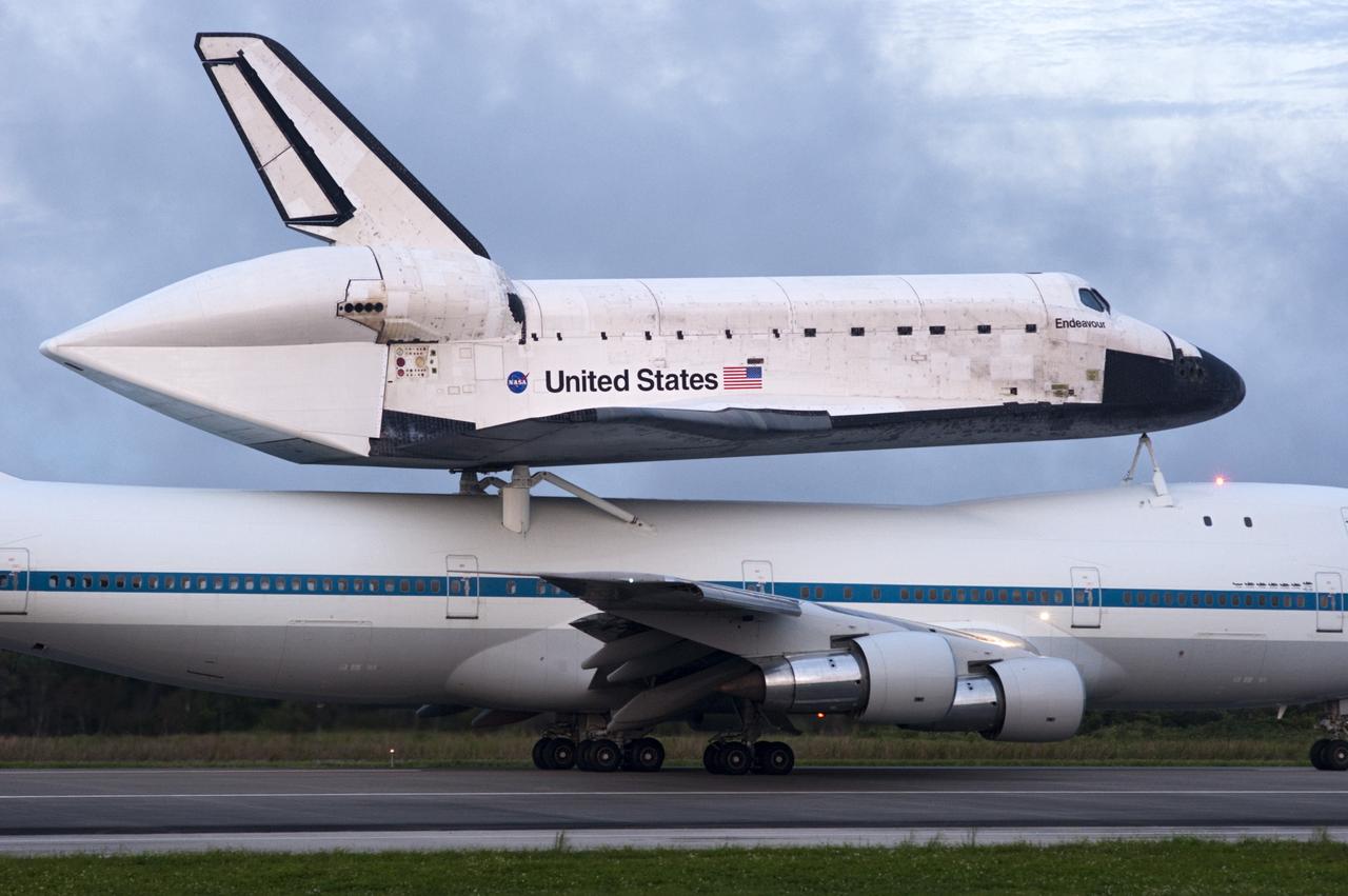 CAPE CANAVERAL, Fla. – Space shuttle Endeavour, mounted atop NASA's Shuttle Carrier Aircraft or SCA, taxis down the runway at the Shuttle Landing Facility at NASA's Kennedy Space Center in Florida. The SCA, a modified 747 jetliner, will fly Endeavour to Los Angeles where it will be placed on public display at the California Science Center. This is the final ferry flight scheduled in the Space Shuttle Program era. For more information on the shuttles' transition and retirement, visit http://www.nasa.gov/transition. Photo credit: NASA/Rusty Backer