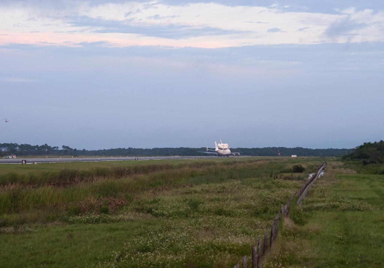CAPE CANAVERAL, Fla. – Space shuttle Endeavour, mounted atop NASA's Shuttle Carrier Aircraft or SCA, taxis down the runway at the Shuttle Landing Facility at NASA's Kennedy Space Center in Florida. The SCA, a modified 747 jetliner, will fly Endeavour to Los Angeles where it will be placed on public display at the California Science Center. This is the final ferry flight scheduled in the Space Shuttle Program era. For more information on the shuttles' transition and retirement, visit http://www.nasa.gov/transition. Photo credit: NASA/Rusty Backer